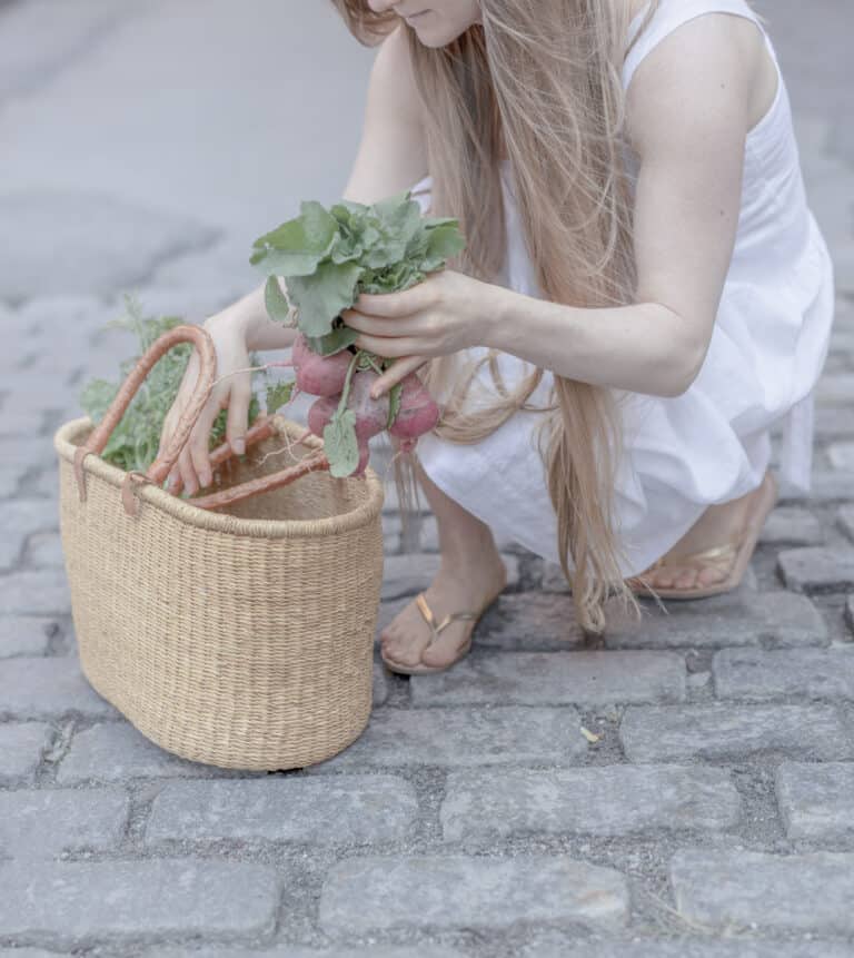 amie valpone on the cobblestone streets in nyc's farmers market.