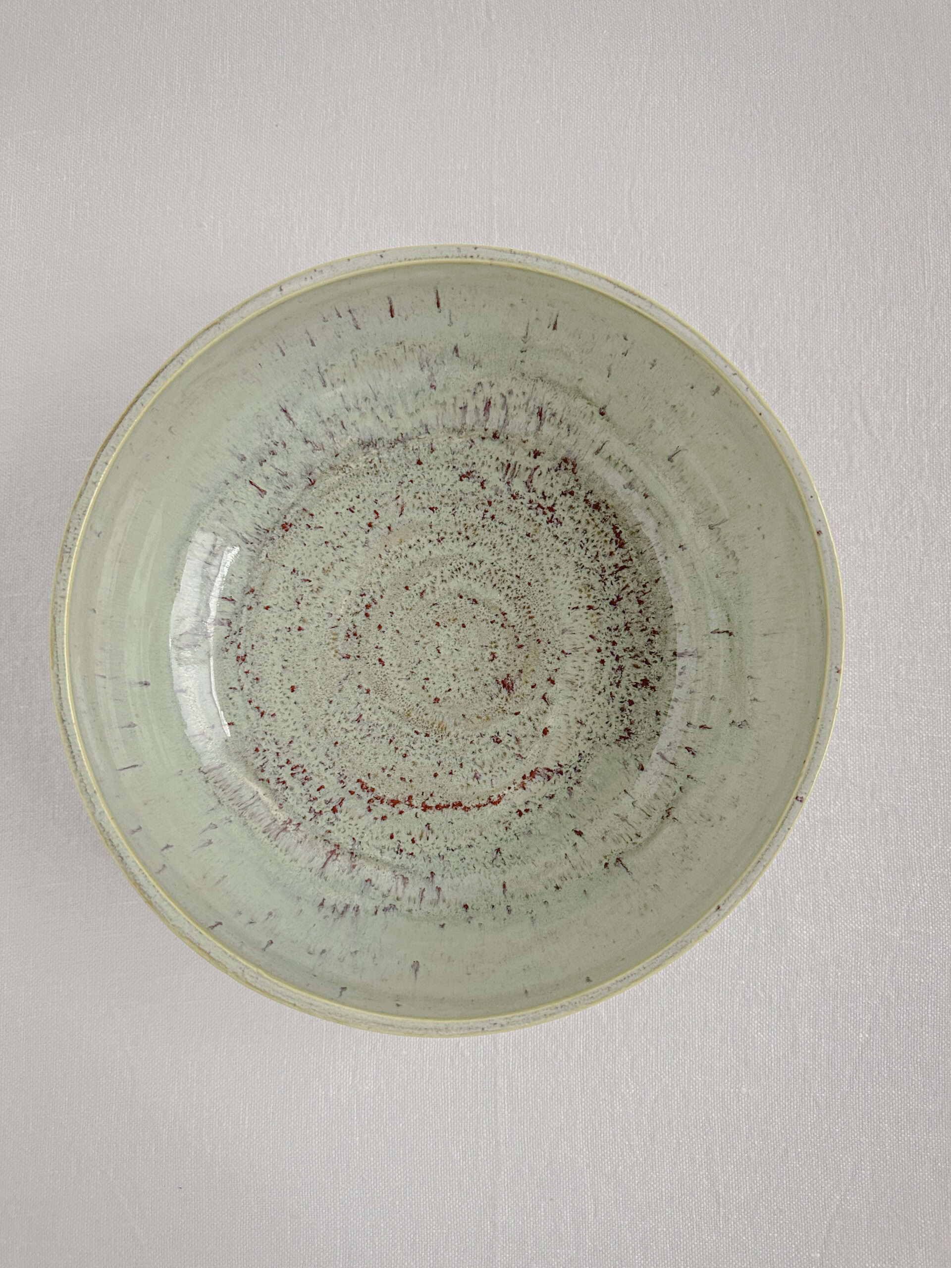 my green speckled pottery bowl on a white table